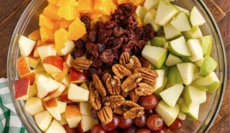 Colorful fall fruit salad with apples, pears, and seasonal fruits in a bowl.
