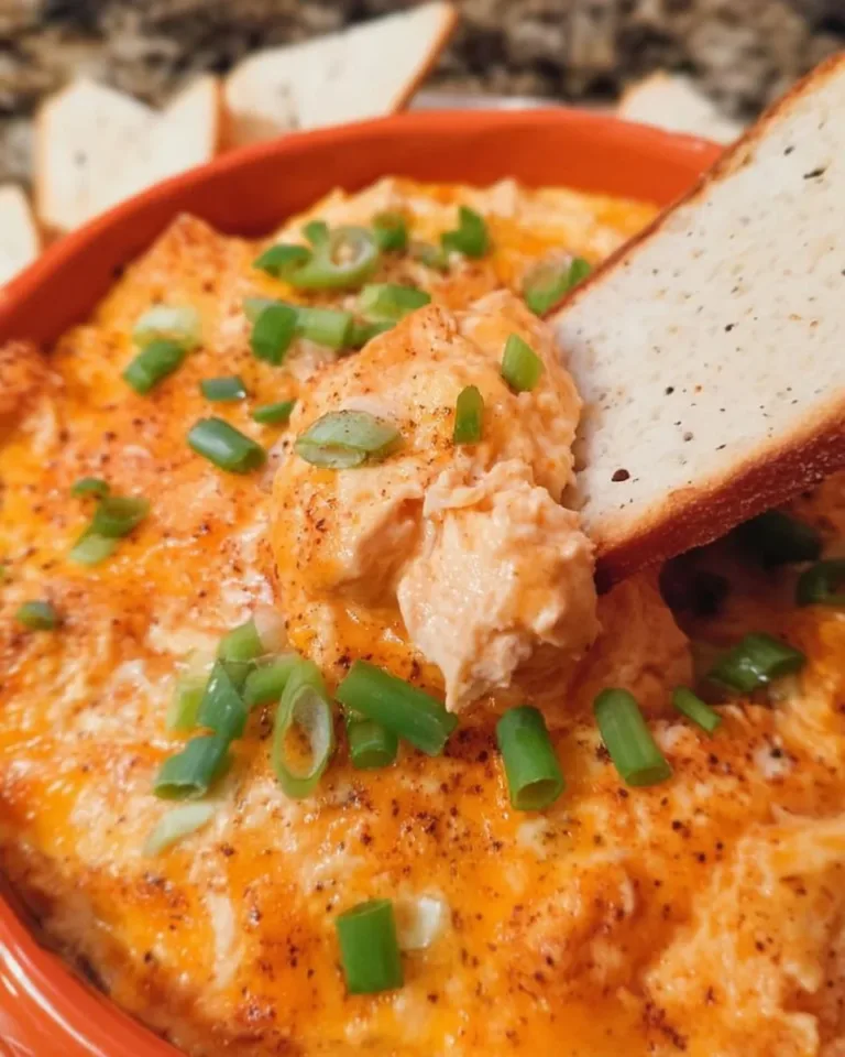 Healthy cottage cheese buffalo chicken dip served in a bowl with celery sticks