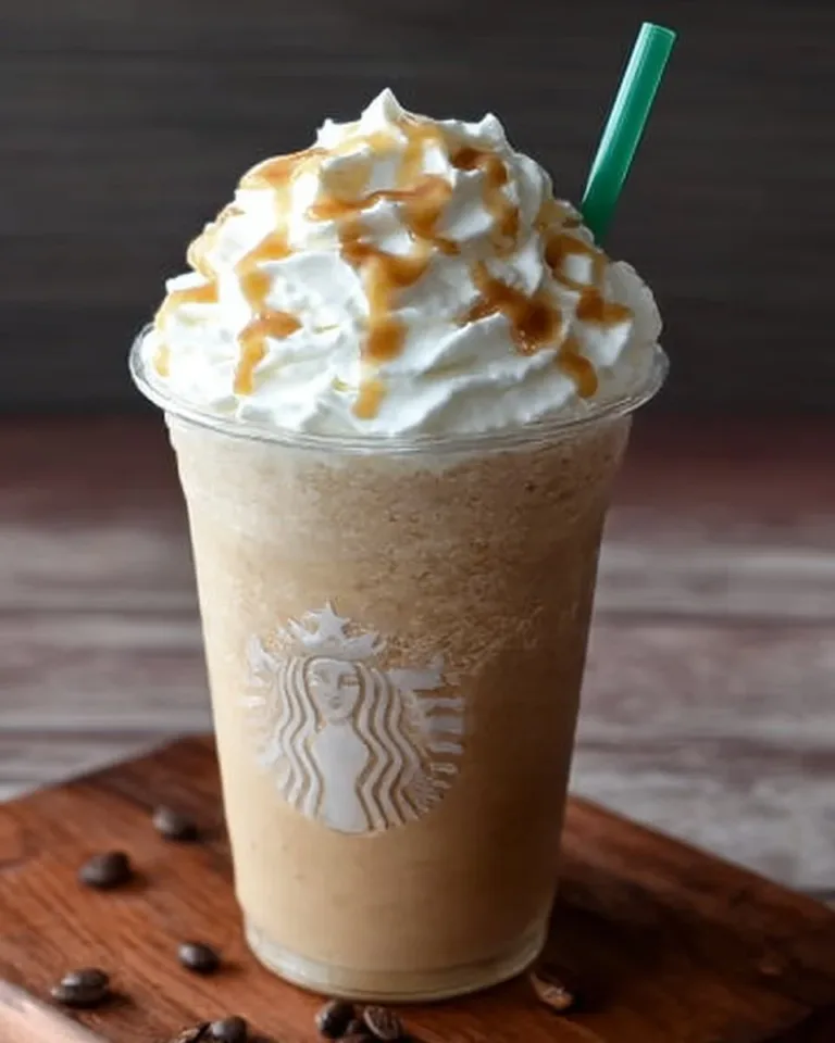Delicious homemade coffee frappuccino served in a clear glass with whipped cream