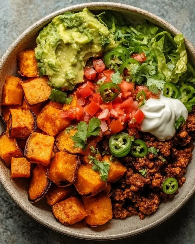 Colorful sweet potato taco bowl with fresh toppings and ingredients