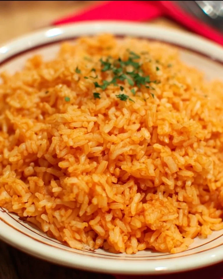 Plate of Andy's homemade Mexican rice garnished with cilantro and lime