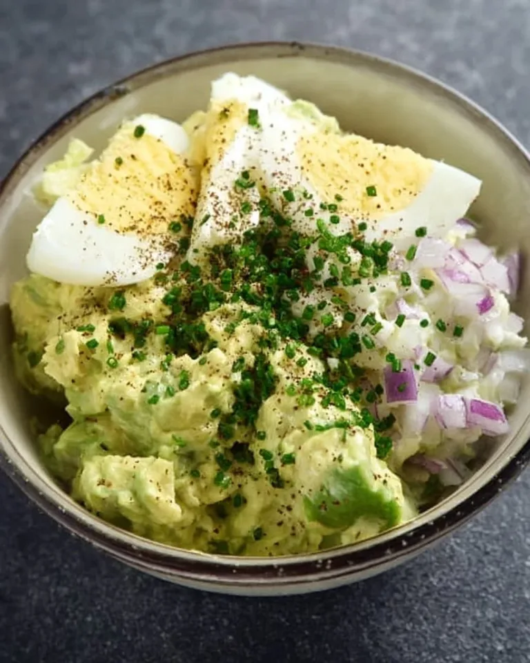 High protein avocado egg salad with fresh ingredients in a bowl